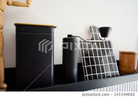 Coffee grinder and coffee accessories are arranged on kitchen shelf in home coffee corner Coffee grinder and coffee accessories are arranged on kitchen shelf in home coffee corner 141349688