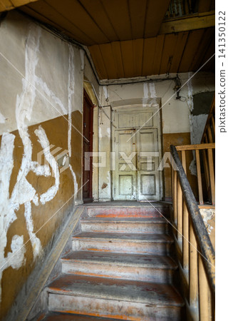 Old worn stairwell in neglected building interior Old worn stairwell in neglected building interior 141350122