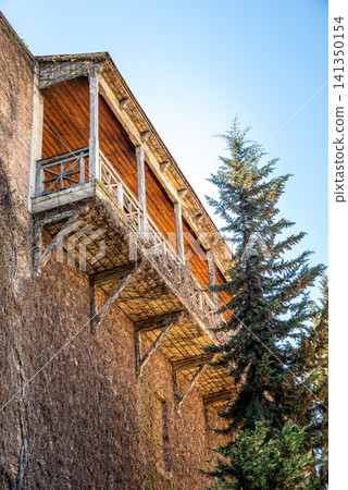 Historic building with wooden balconies and tree Historic building with wooden balconies and tree 141350154