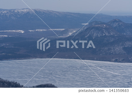 Overlooking the frozen lake and mountain range Overlooking the frozen lake and mountain range 141350683
