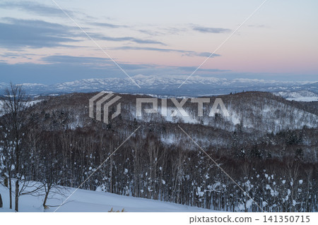 A sky tinged pink and snow-capped mountains A sky tinged pink and snow-capped mountains 141350715