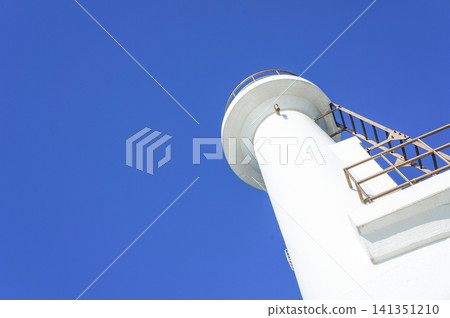 The beauty of a white lighthouse stretching into the blue sky and its simple composition. The beauty of a white lighthouse stretching into the blue sky and its simple composition. 141351210