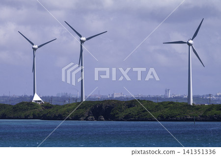 Wind turbines operating at Nishihira Ana Cape, with the beautiful sea of Miyako Island as a backdrop. Wind turbines operating at Nishihira Ana Cape, with the beautiful sea of Miyako Island as a backdrop. 141351336