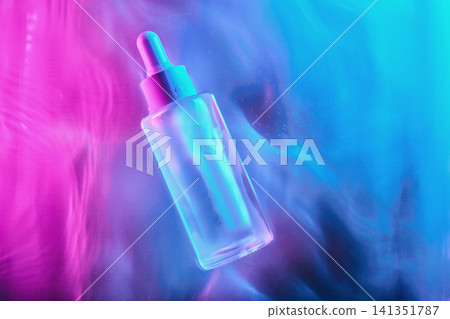 Skincare serum bottle glowing in neon futuristic lighting Skincare serum bottle glowing in neon futuristic lighting 141351787
