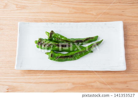 Grilled Manganji peppers served on a square plate Grilled Manganji peppers served on a square plate 141353527