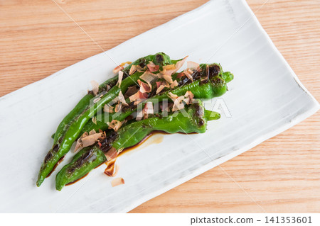 烤滿乾辣椒,撒上鰹魚片和醬油 烤滿乾辣椒,撒上鰹魚片和醬油 141353601