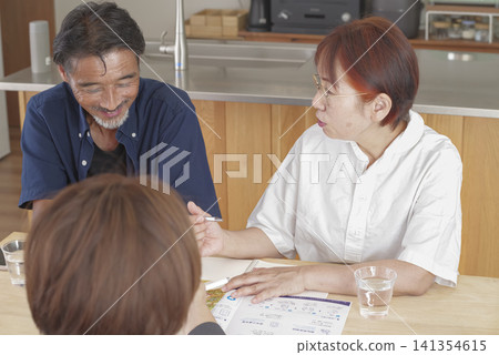 A couple discussing long-term care insurance and care services. A couple discussing long-term care insurance and care services. 141354615