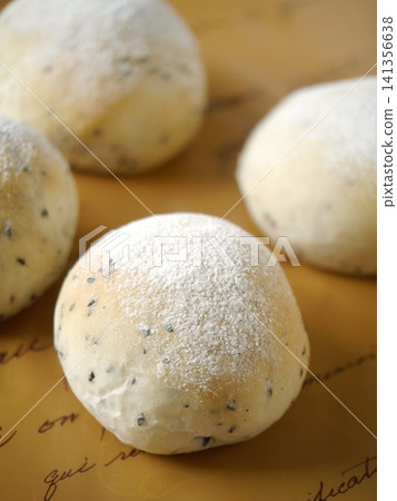 Black sesame round bread, brown background Black sesame round bread, brown background 141356638