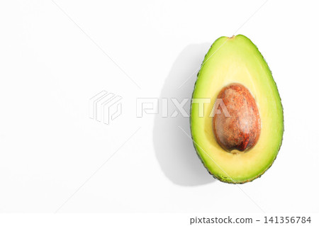 Avocado Half on White Background with Copy Space Avocado Half on White Background with Copy Space 141356784