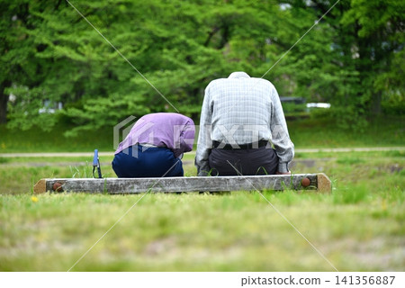 Two senior men resting on a bench Two senior men resting on a bench 141356887