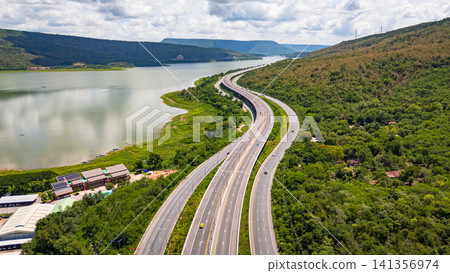 Drone shot The M6 motorway Nakhon Ratchasima Province - Bang Pa-in Lam Ta Khong River and Mountain. Motorway Korat Thailand Drone shot The M6 motorway Nakhon Ratchasima Province - Bang Pa-in Lam Ta Khong River and Mountain. Motorway Korat Thailand 141356974