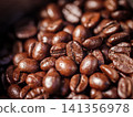 Close-up of freshly roasted coffee beans inside a coffee grinder hopper. Rich texture and aroma for espresso concept 141356978