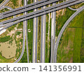 Drone shot a large highway interchange crossing over green farmlands in Thailand 141356991