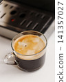 Close-up of freshly brewed black coffee served in a clear glass cup 141357027