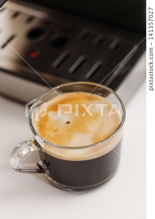 Close-up of freshly brewed black coffee served in a clear glass cup 141357027