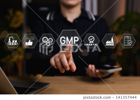 Concept of Good Manufacturing Practice (GMP) in modern industry. Person touching GMP certified icons related to quality control, production standards, factory certification for product safety process. Concept of Good Manufacturing Practice (GMP) in modern industry. Person touching GMP certified icons related to quality control, production standards, factory certification for product safety process. 141357444