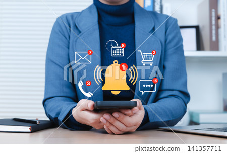 Notification Alert and Digital Communication Concept. Businessperson checks smartphone with floating multiple notification icons for messages, calls, emails, calendar events, real-time communication, Notification Alert and Digital Communication Concept. Businessperson checks smartphone with floating multiple notification icons for messages, calls, emails, calendar events, real-time communication, 141357711