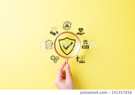 Work Safety and Compliance Concept. Magnifying glass over shield with check mark surrounded by icons symbolizing workplace safety, inspection, training, compliance, health protection, risk management, 141357856