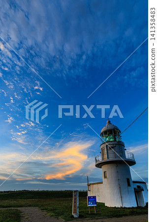 A breathtaking view of the historic lighthouse in Erimo Town, Hokkaido, bathed in the refreshing blue summer sky and the light of the rising sun. A breathtaking view of the historic lighthouse in Erimo Town, Hokkaido, bathed in the refreshing blue summer sky and the light of the rising sun. 141358483