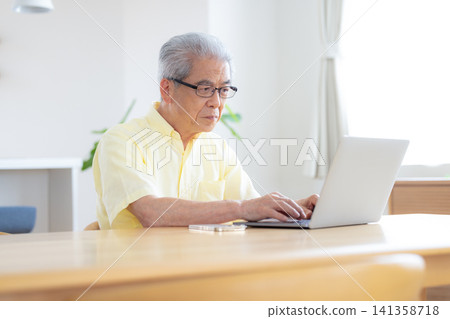 Senior men operating a computer Senior men operating a computer 141358718