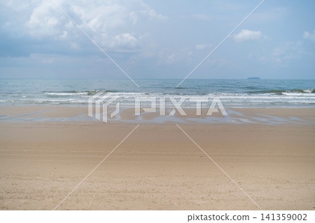 Wide open empty sandy beach with gentle sea waves and soft cloudy sky stretching to the horizon. Peaceful seascape concept Wide open empty sandy beach with gentle sea waves and soft cloudy sky stretching to the horizon. Peaceful seascape concept 141359002