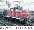 A freight train pulled by a DE10 diesel locomotive (No. 67) stopped in a station yard during the Japanese National Railways era. 141359180