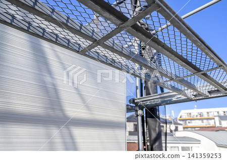 Scaffolding and open sky for flat roof renovation work Scaffolding and open sky for flat roof renovation work 141359253