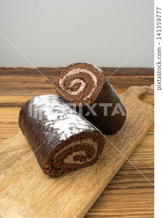 Chocolate Swiss Roll, Round Sponge Cake, Sliced Rolled Vanilla Biscuit with Cocoa Cream Filling Chocolate Swiss Roll, Round Sponge Cake, Sliced Rolled Vanilla Biscuit with Cocoa Cream Filling 141359777