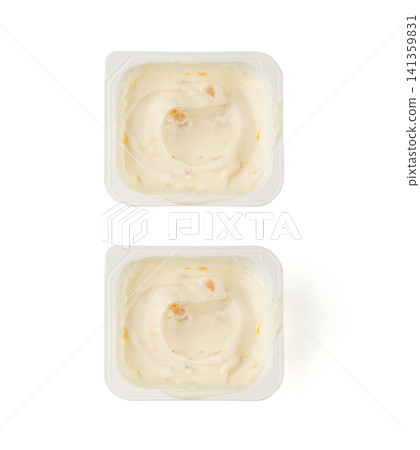 Yogurt cup isolated, yoghurt with orange fruits pieces in plastic pot, milk pudding container Yogurt cup isolated, yoghurt with orange fruits pieces in plastic pot, milk pudding container 141359831