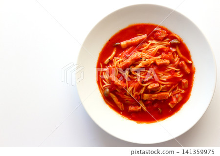 Tomato soup pasta viewed from directly above against a white background. Tomato soup pasta viewed from directly above against a white background. 141359975