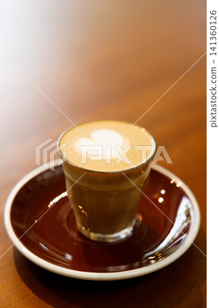 Glass of milk latte coffee on a wooden table. 141360126