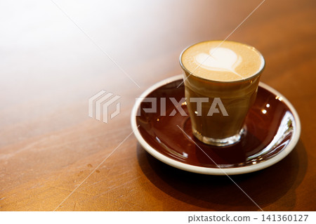 Glass of milk latte coffee on a wooden table. Glass of milk latte coffee on a wooden table. 141360127