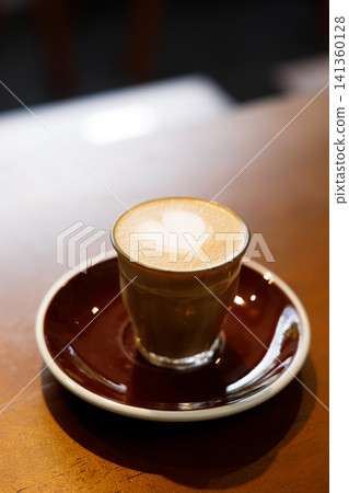 Glass of milk latte coffee on a wooden table. Glass of milk latte coffee on a wooden table. 141360128