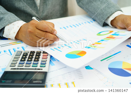Asian business woman working with financial graph. Asian business woman working with financial graph. 141360147