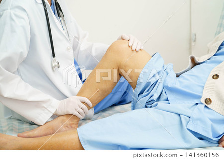 Doctor checking Asian elderly woman patient with scar knee replacement surgery in hospital. Doctor checking Asian elderly woman patient with scar knee replacement surgery in hospital. 141360156