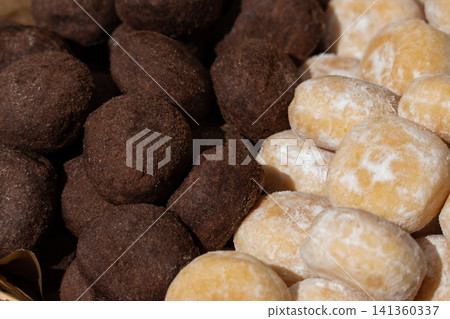 Chocolate truffle balls, cocoa and hazelnut round cookies close up 141360337