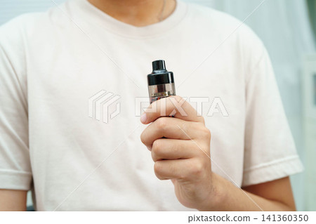 Man holding electronic cigarettes, no smoking. Man holding electronic cigarettes, no smoking. 141360350