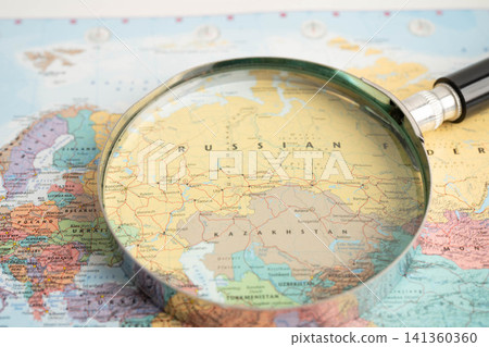 Bangkok, Thailand May 15, 2022 Magnifying glass on world map. Bangkok, Thailand May 15, 2022 Magnifying glass on world map. 141360360