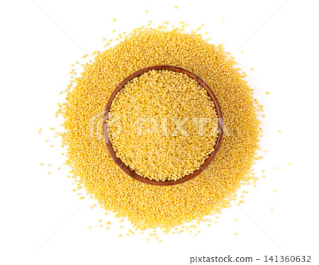 Raw millet grains pile isolated. Little yellow cereal, natural foxtail small seeds Raw millet grains pile isolated. Little yellow cereal, natural foxtail small seeds 141360632