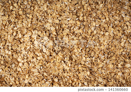 Oat flakes textured pattern, rolled oatmeal macro background Oat flakes textured pattern, rolled oatmeal macro background 141360660