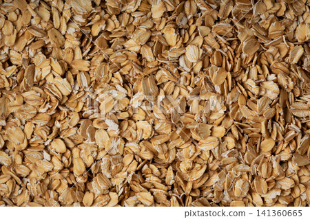 Oat flakes textured pattern, rolled oatmeal macro background Oat flakes textured pattern, rolled oatmeal macro background 141360665