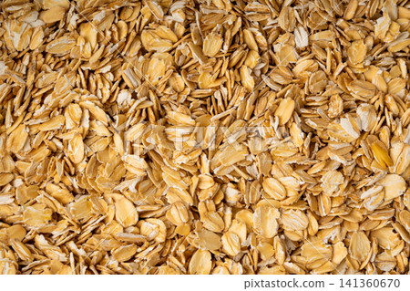 Oat flakes textured pattern, rolled oatmeal macro background 141360670