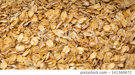 Oat flakes textured pattern, rolled oatmeal macro background 141360672