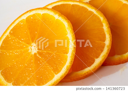 Orange fruit slice macro textured background Orange fruit slice macro textured background 141360723