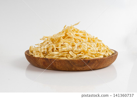 Passatelli spatzle pasta isolated, raw spaetzle noodles, dry homemade german macaroni Passatelli spatzle pasta isolated, raw spaetzle noodles, dry homemade german macaroni 141360737