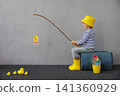 Happy child playing indoor. Kid enjoying a fishing trip. Little boy having fun at home 141360929