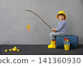 Happy child playing indoor. Kid enjoying a fishing trip. Little boy having fun at home 141360930