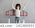 Happy child pretend to be astronaut. Funny kid with paper rocket. Little boy playing indoors 141360933