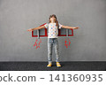 Happy child pretend to be astronaut. Funny kid with paper rocket. Little boy playing indoors 141360935