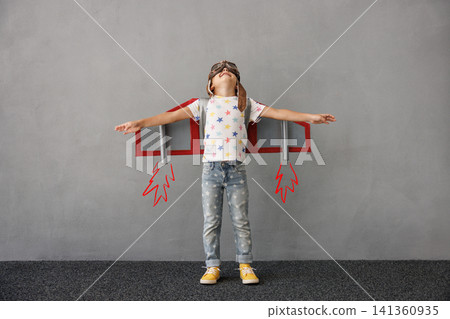 Happy child pretend to be astronaut. Funny kid with paper rocket. Little boy playing indoors Happy child pretend to be astronaut. Funny kid with paper rocket. Little boy playing indoors 141360935